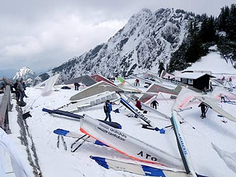 Brooms were on hand to brush the snow from gliders at the women's Hang Gliding World Championships 2010. 